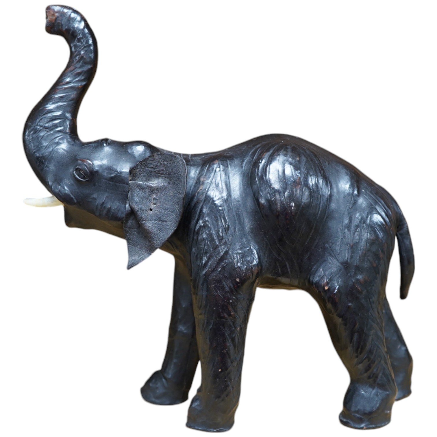 A small leather covered model of an elephant, stamped Liberty, 31cm. Condition - fair